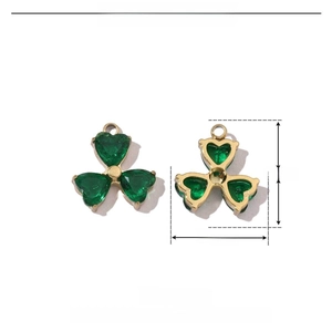 Macro view of stainless steel clover charm with green rhinestones and 12x13mm dimensions