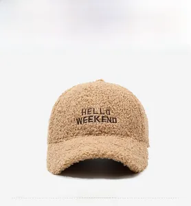 Detail of camel faux lamb wool baseball cap featuring Hello Weekend black embroidery