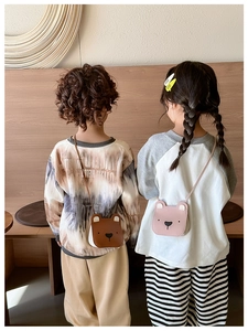 Detailed view of children's cute bear crossbody bags in brown and pink on models
