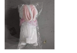 Glow-in-the-dark plush bunny ornament in protective clear packaging for Christmas gift