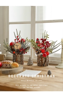 Cozy Christmas tabletop floral arrangement with red berries, pine cones and LED lights