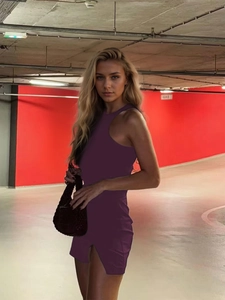 Detail view of the side slit on a deep purple slim-fit bodycon mini dress for women