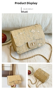 Detail of khaki straw saddle bag with floral embroidery and golden metal flip lock