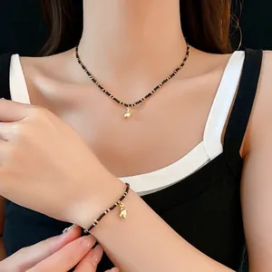 Bohemian seashell necklace and bracelet set with black beads and gold shell charms