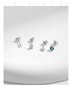 Detail of S925 silver stud earring set with green clover, lock and zircon studs