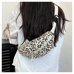 Detail showing leopard print woven waist bag with white strap and buckle on model