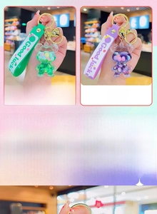 Close-up of green and purple acrylic bear keychains with liquid quicksand and glitter