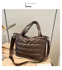 Detail of a brown quilted tote bag with metallic finish, showing straps and textures