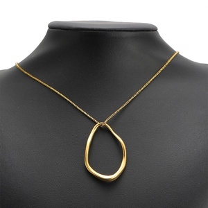 Gold-plated stainless steel necklace with oversized irregular oval pendant on black model