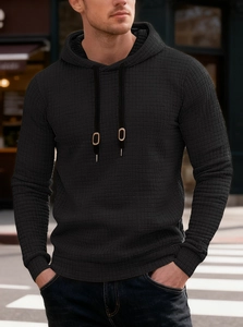 Detail of black waffle knit fabric and drawstring on men's long sleeve hooded sweatshirt
