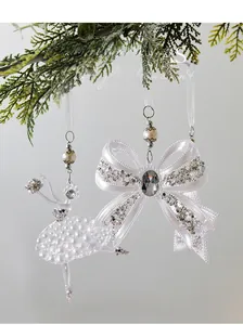 Detail of acrylic ballerina and bow Christmas ornaments with silver glitter and pearls