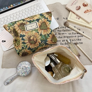Flat lay of sunflower jacquard cosmetic bags with zipper closure and large capacity