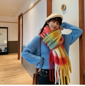 Close-up of rainbow plaid scarf with long fringes and soft mohair texture