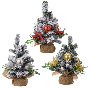 Miniature snowy Christmas trees set with red, gold and silver ornaments on burlap base