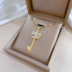 Luxurious gold flower key pendant necklace with sparkling crystals in a gift box