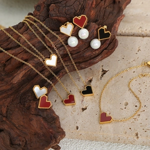 Romantic gold heart jewelry set featuring shell pendants, pearls, and acrylic beads