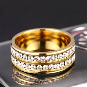 Detail of a wide gold titanium ring featuring double-row sparkling crystal pavé settings