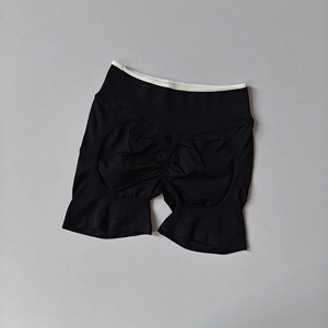 Detail of high-waisted seamless yoga shorts showing scrunch butt texture and contrast color