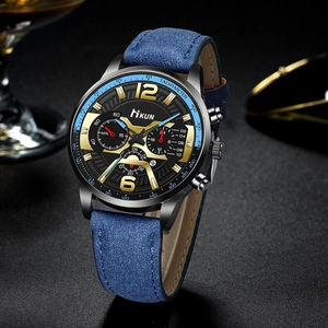 Detail of square business watch featuring blue leather strap and chronograph sub-dials