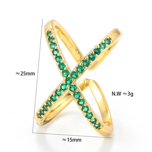 Detail view of gold crisscross ring with green stones showing 25mm height and 3g weight