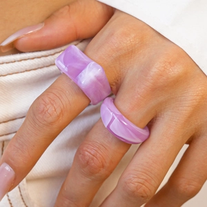 Detail of purple marble resin ring set showing unique swirl texture and geometric design