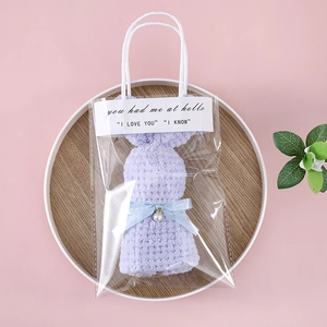 Detail of purple bunny-shaped coral fleece towel in transparent PVC gift bag