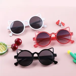 Flat lay of child cat ear sunglasses in white, translucent red and black colors