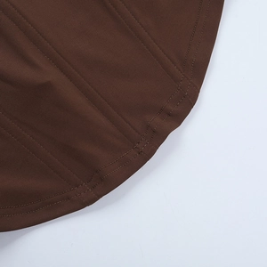 Macro shot of double-needle stitching on a brown corset top hem for a high-quality finish