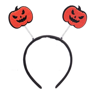 Detail of Halloween headband featuring spring-mounted orange felt pumpkins on a black band