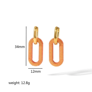 Detail view of gold textured hoop earrings showing 34mm height and 12.8g weight