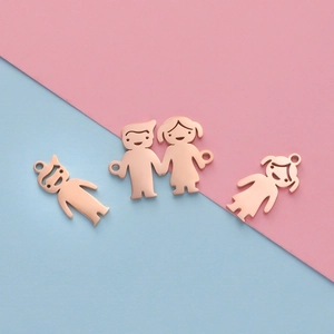 Detailed view of rose gold family charms featuring parents, boy and girl on split background