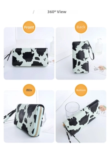 Multi-angle view of cow print women long wallet with wristlet and gold zipper detail