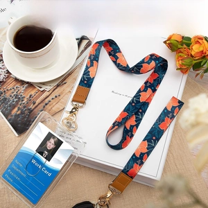 Floral print polyester wrist lanyard with transparent ID card holder and gold metal clasp