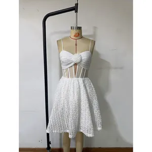 Detail of white A-line dress featuring 3D floral lace texture and corset-style bodice