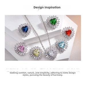 Close-up of heart-shaped colored zircon jewelry set on a minimalist white stand