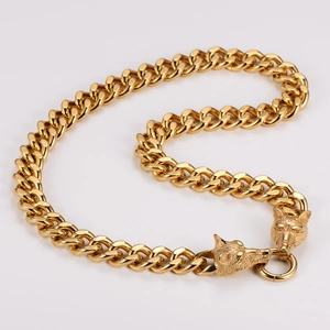Close-up of golden Viking double wolf head clasp on a heavy Cuban link chain necklace