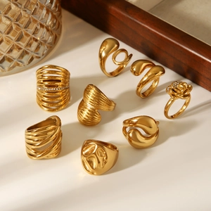 Detail view of 8-piece 18k gold plated stainless steel ring set in diverse textures
