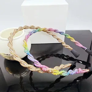 Detail of twisted crystal headbands in champagne gold and rainbow colors on mirror