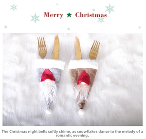 Detail of Christmas gnome cutlery holders in grey and brown on white faux fur background