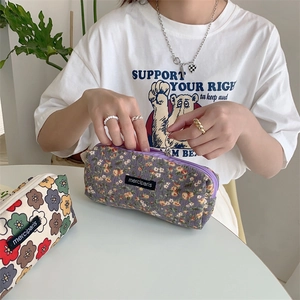 Detail of floral corduroy pencil case with metal zipper and brand label merciparis