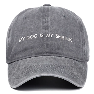 Detailed view of white embroidery My Dog Is My Shrink on washed grey cotton baseball cap