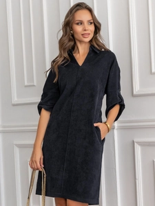 Detail of dark blue corduroy shirt dress with V-neck collar and side pockets