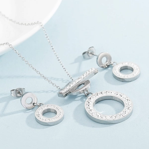 Detailed view of silver T-bar necklace and diamond-encrusted geometric earrings set