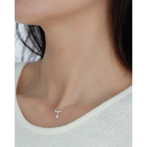 Close-up of elegant S925 silver snowflake necklace with sparkling zircon on model's neck