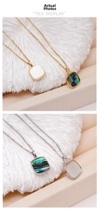 Detailed close-up of square mother of pearl and abalone shell pendants on 18K gold chains
