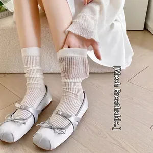 White breathable mesh crew socks with vertical stripes paired with silver Mary Jane shoes