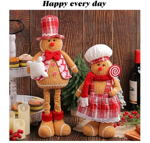 Detailed plush gingerbread dolls in festive indoor holiday setting with Christmas decorations