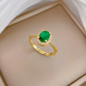 Adjustable gold ring with emerald oval stone and pavé zircon set in jewelry box