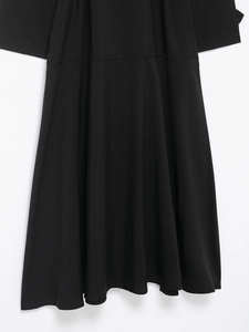 Detailed fabric texture and waist tie design of a black British style midi trench dress