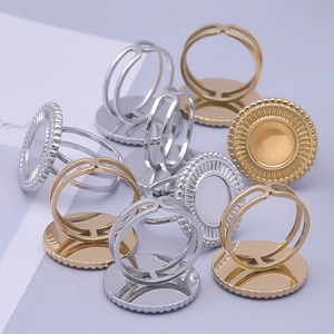 Close-up of adjustable stainless steel ring bases with beaded round bezel trays in gold and silver